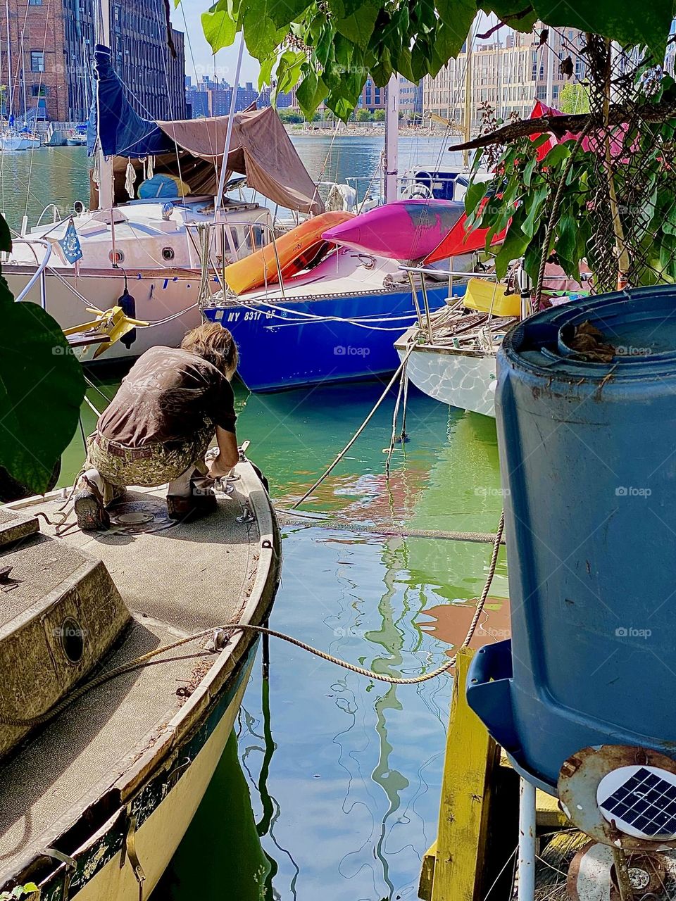 Through the foliage of this big old tree you see my longtime partner and friend „Timothy Trespas“ attend to some kind of problem with the boats. He is really good at troubleshooting as well as fixing things. 2023. Hypnotic Productions