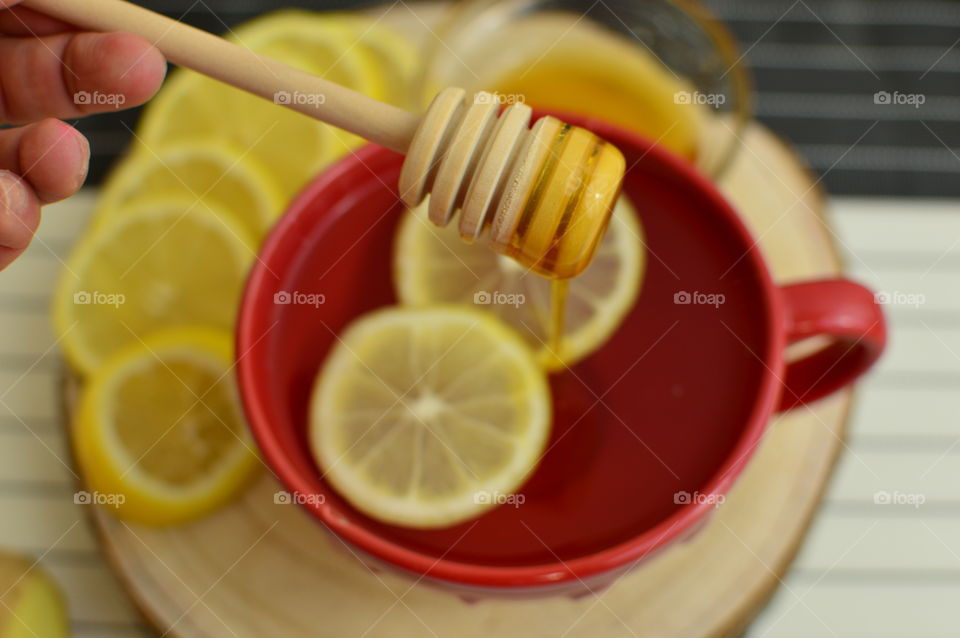 detoxifying herbal tea with lemon in red cup