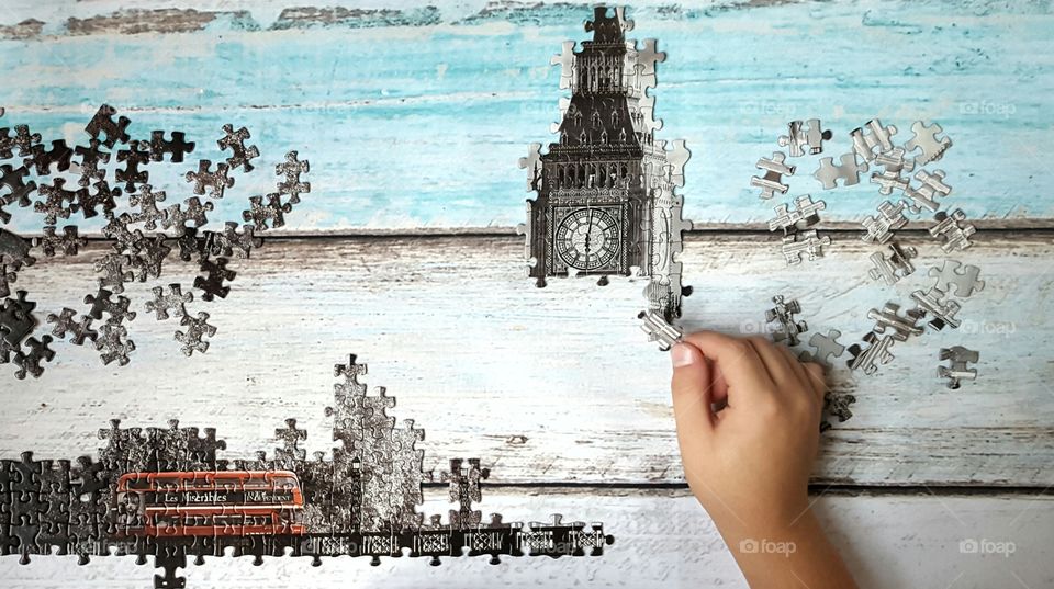 Person playing puzzle on table