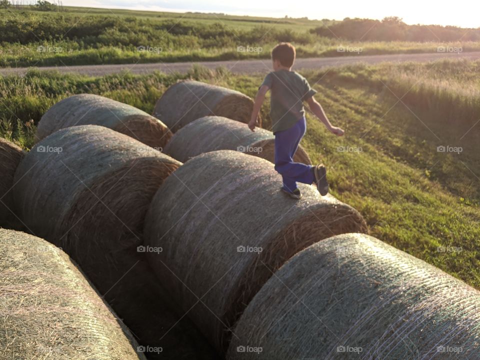 Boy playing on hay
