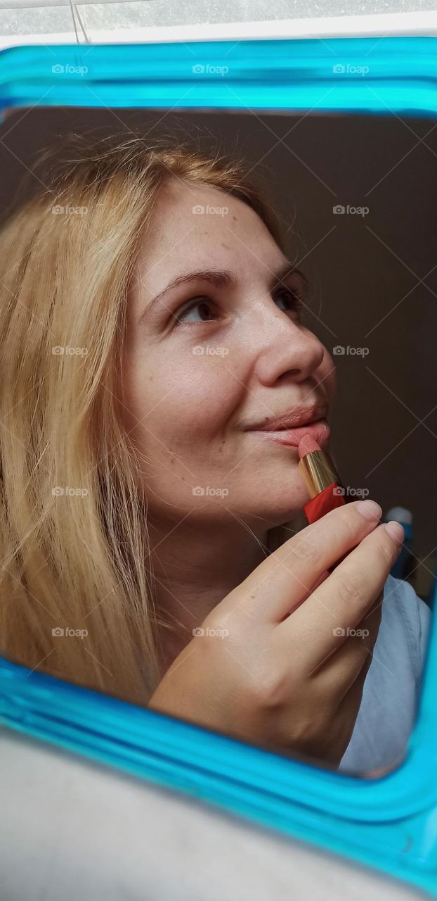 girl paints her lips