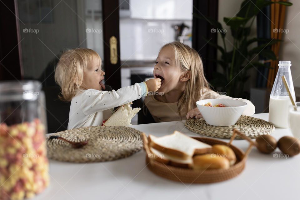 Happy siblings having fun at home