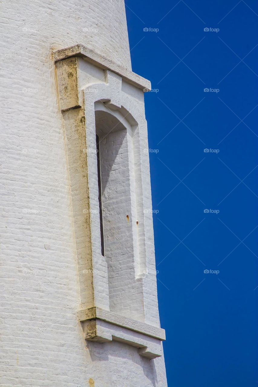 Pigeon Point Light House off highway one in California, beautiful white painted brick against a clear vibrant blue sky, you can feel the age of this old landmark