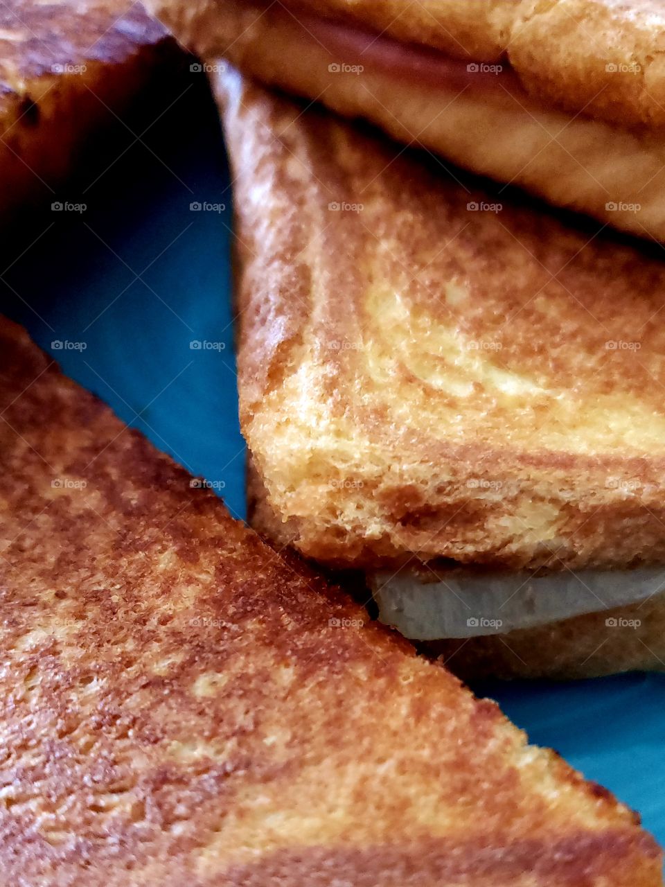 Closeup texture of a hot delicious toasted ham and cheese sandwich