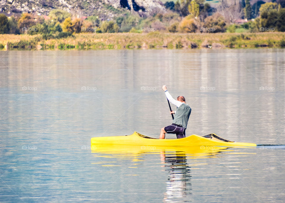 Single Rower At The Lake On A Sunny Day
