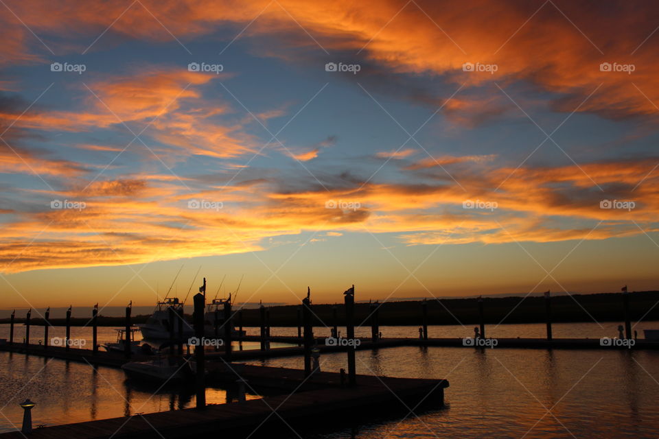 Silhouette of dock in the sea during sunset