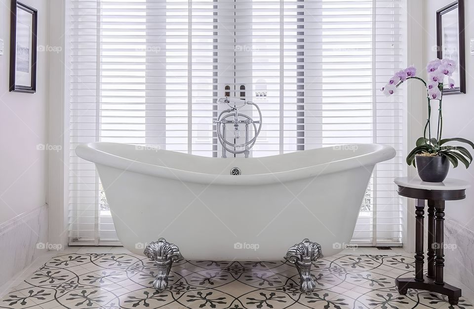 bathtub in a white baht room