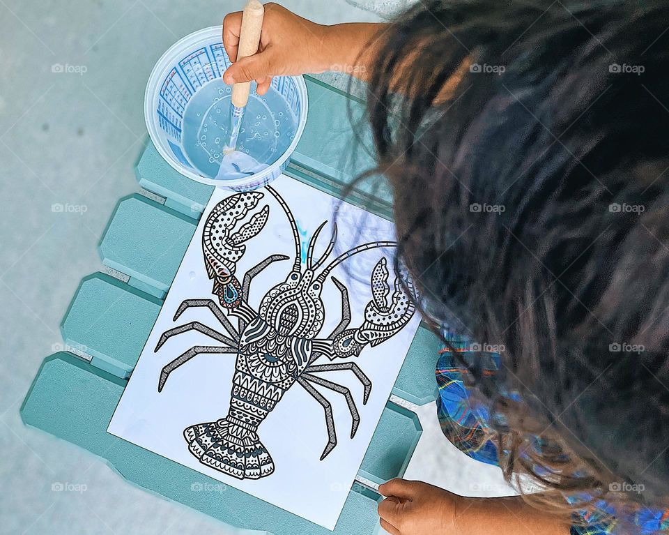Toddler painting a lobster, lobster painting, painting with water, less mess painting, child paints a lobster picture, child painting, getting creative with children, creating with children, toddlers and paints 