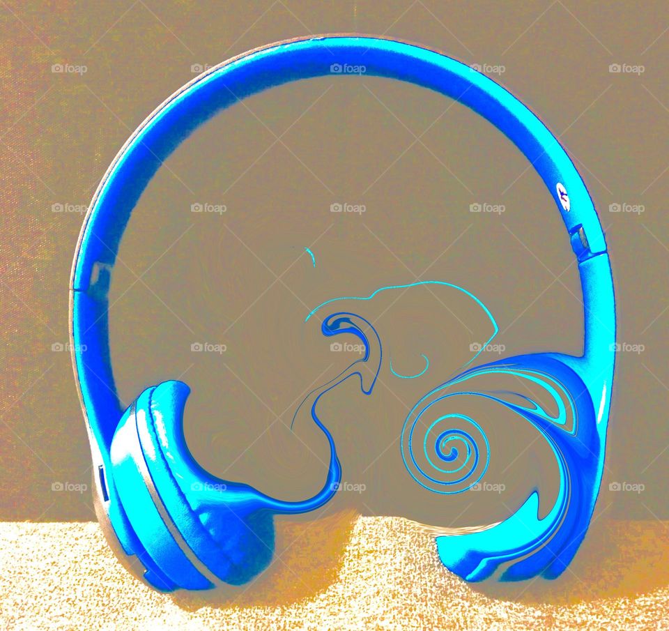 Digital abstract, blue headphones dissolving to the sound of music