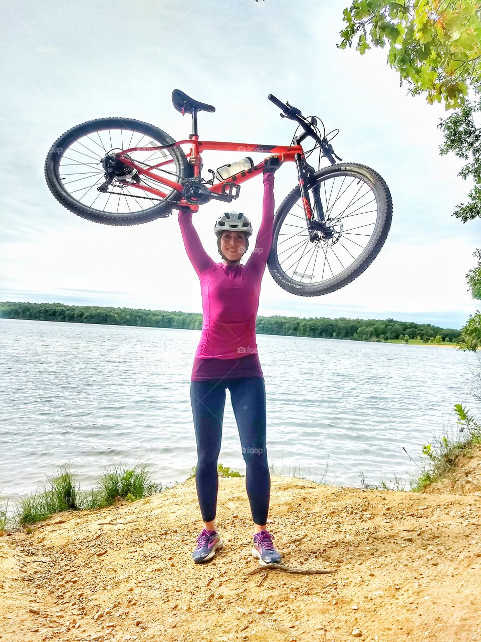 strong woman holds up bike