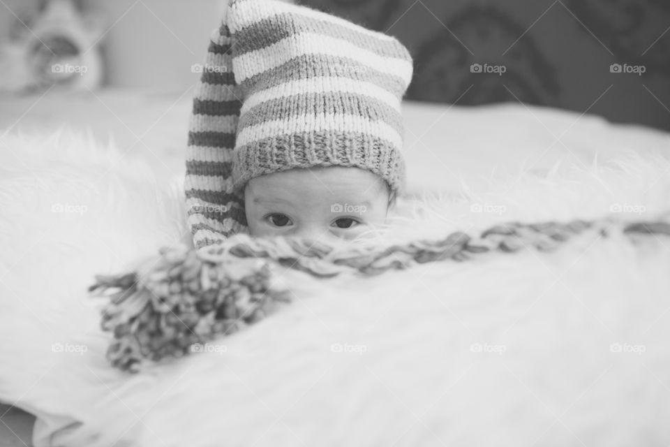 It's a baby. He is my nephew on the day of his christening. I was the photographer who was in charge of his christening. In the photo only the eyes appear. Under the baby I have put a soft blanket.