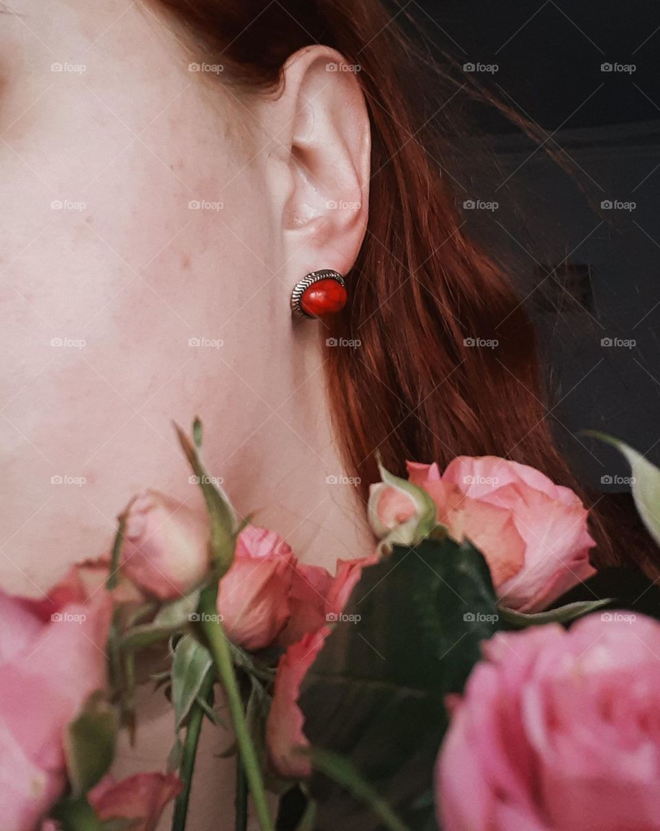 Portrait with red earrings and flowers