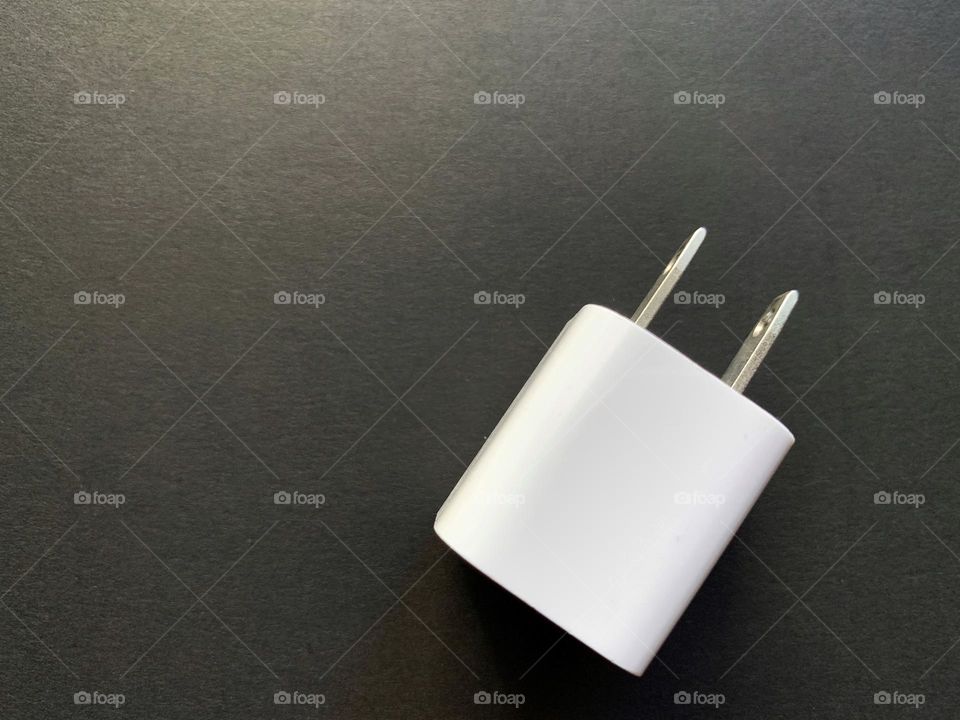 White wall charger against black background.