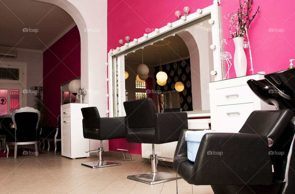 beauty salon. hair dresser seats in nicely decorated beauty salon
