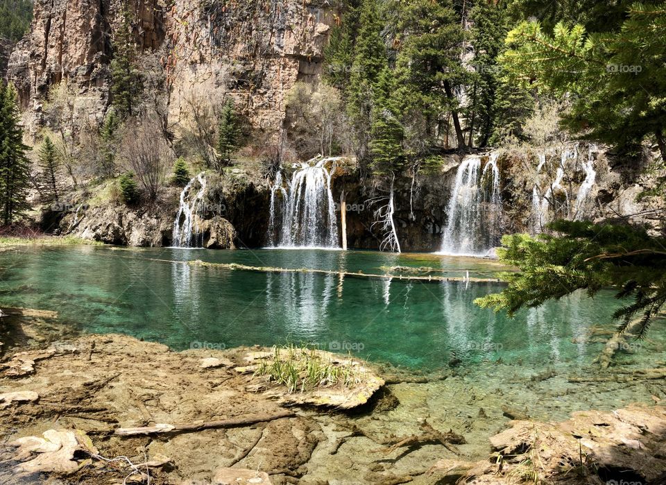 Beautiful crystal clear water flowing from a waterfall into a Colorado lake high in the mountains. 