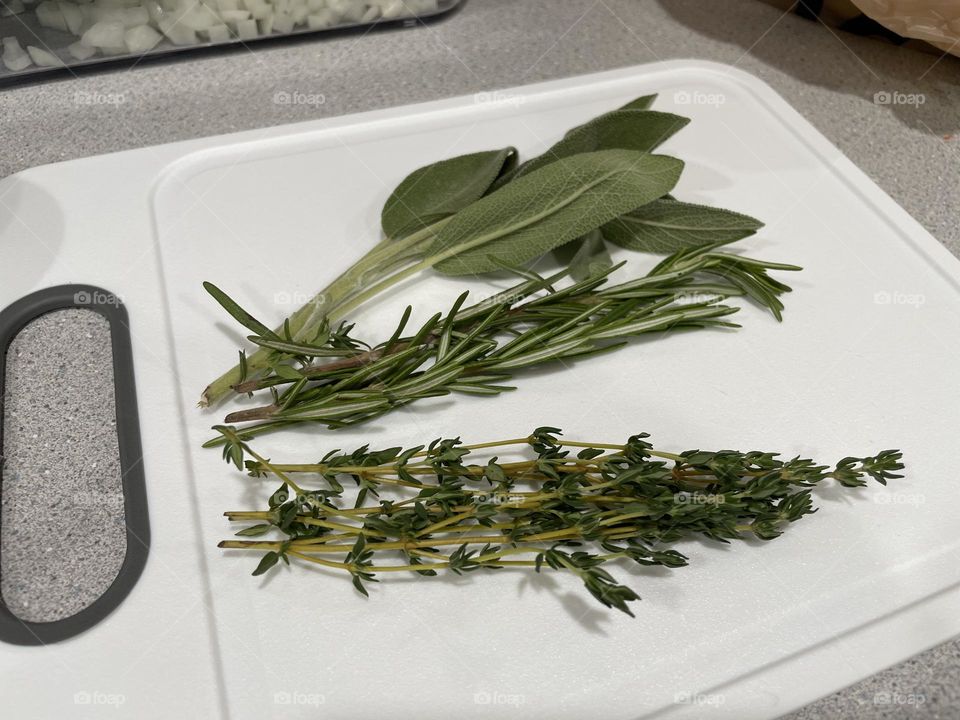 Herbs on a cutting board, cutting herbs for dinner, making dinner for the family 