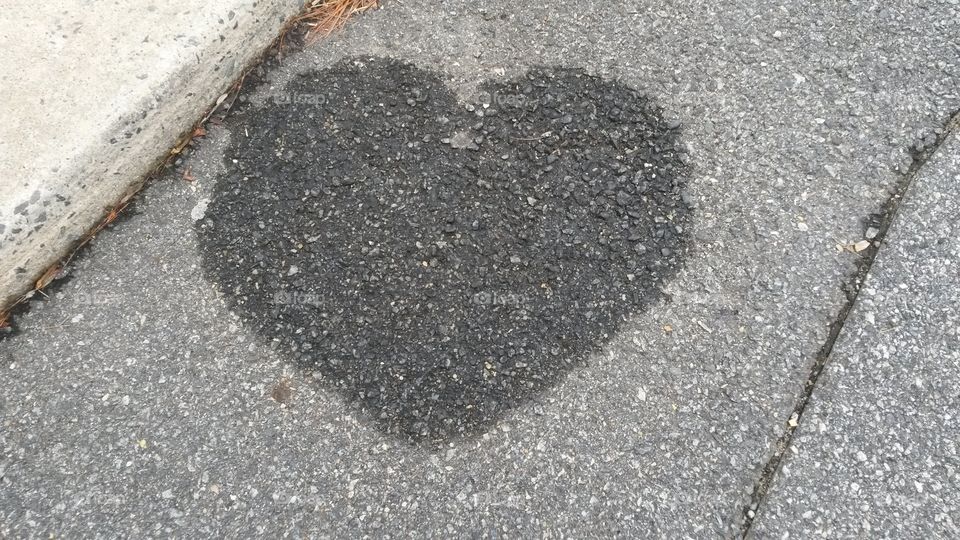 random heart. a waterspot found in a parkinglot