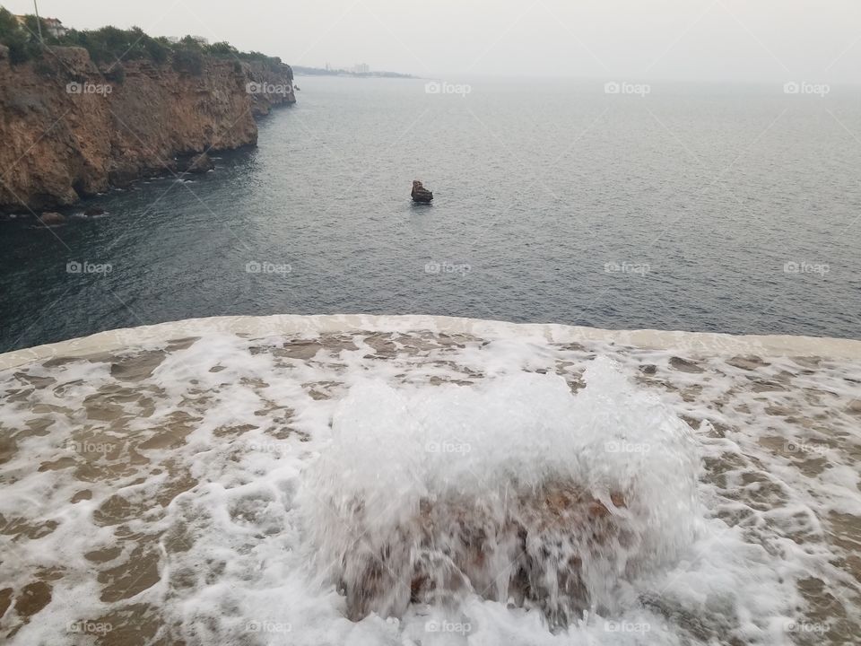 waterfall flowing off a cliff and into the sea in Antalya turkey