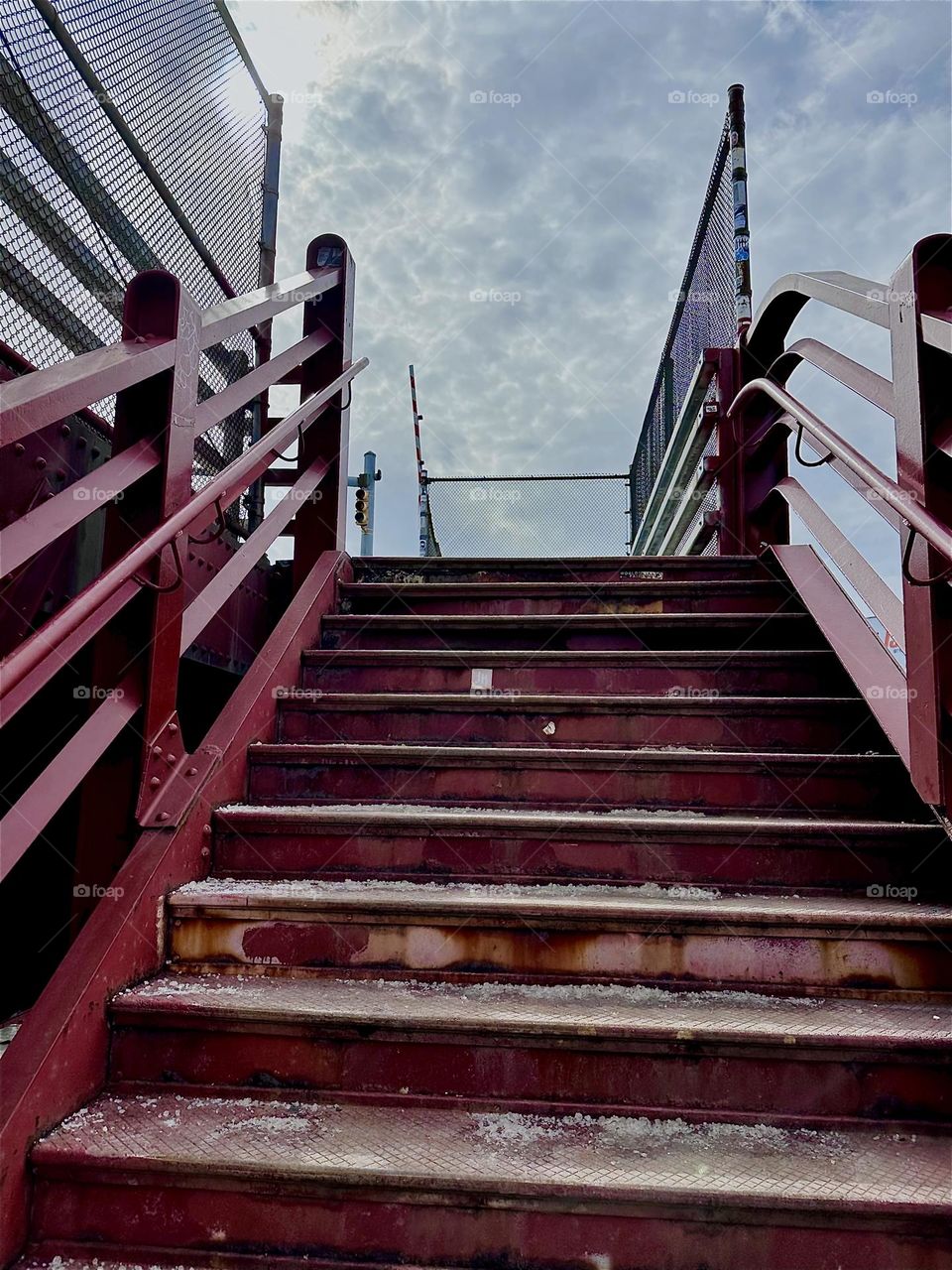 This is the red metal staircase that leads up to the “Pulaski Bridge” at “Newtown Creek“ that connects LIC to „Greenpoint“, Bklyn. Its minimalist aesthetic reminds of the „Bauhaus“ school in „Weimar“, Germany of the 1930s. 2024. Hypnotic Productions