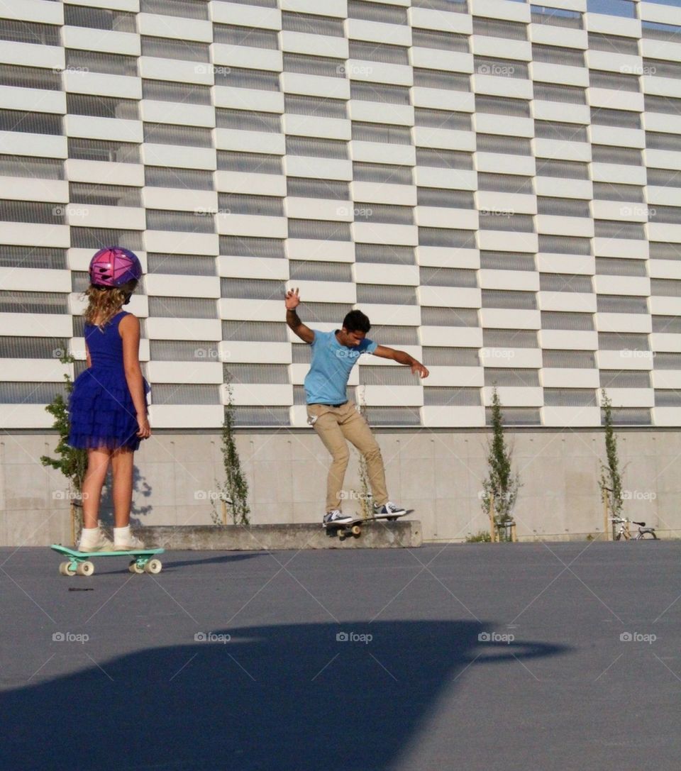 Skateboarding girl and boy.