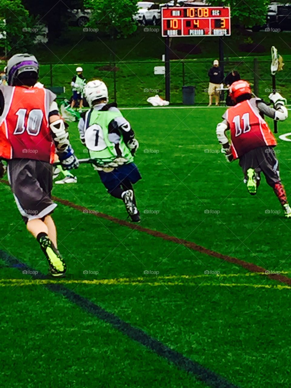 Boys youth lacrosse running in unison