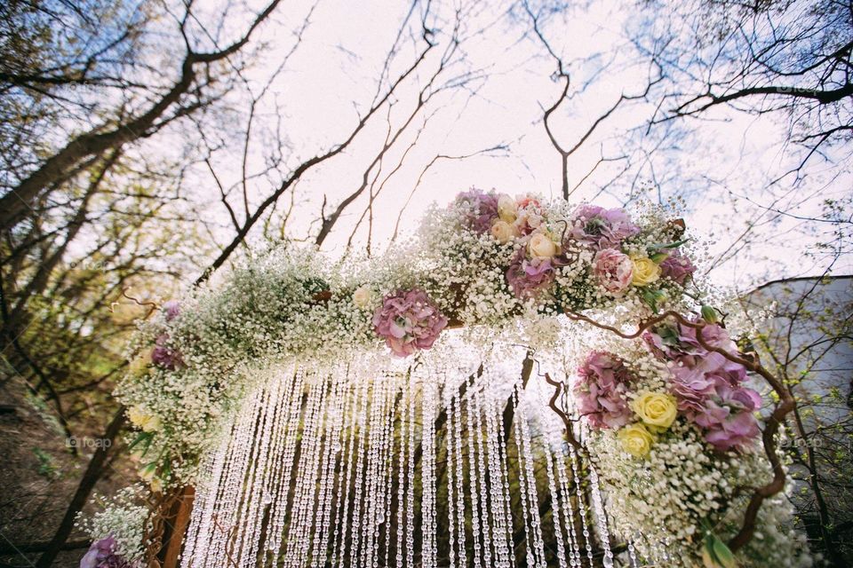 A part of a wedding flower arch. A refined floral composition with cascading strands of glass beads. Perfect as a background 