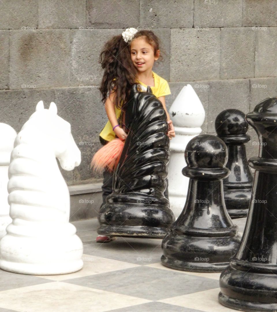young girl playong chess in Erevan