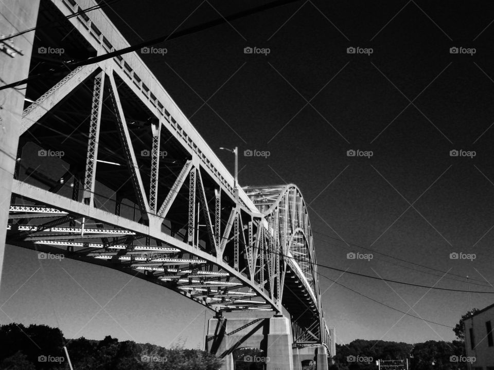 Sagamore Bridge connecting Massachusetts to Cape Cod. Pic taken looking up at bridge.
There are two identical bridges that are like this photo. This Canal saves much time for boats & ships for whatever their reason from going all the way around the Cape.