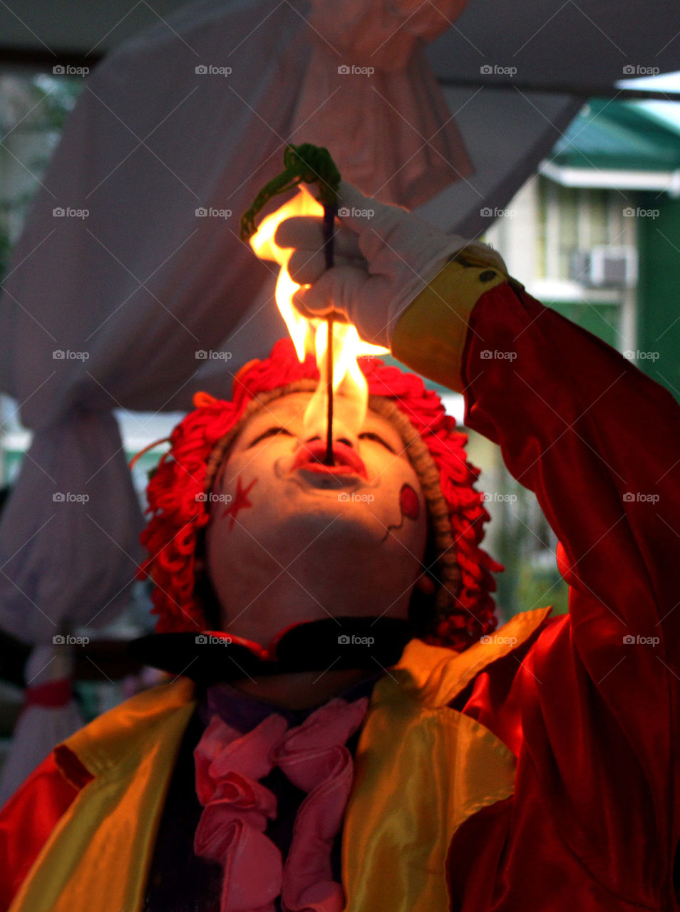 Jade, the clown fire eater on his performance