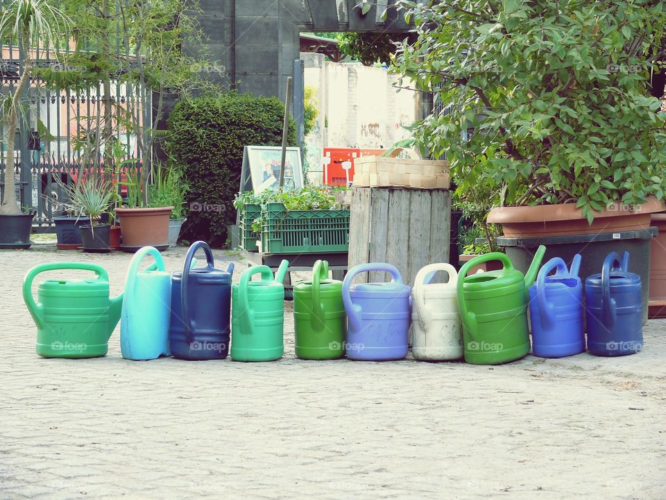 Watering cans in a row on a cemetery in Berlin, Germany.