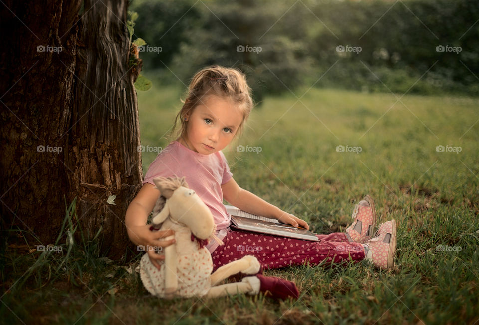 Girl reading the book outdoor