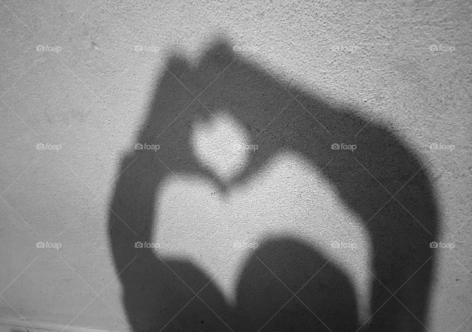 children's shadow making heart with hands
