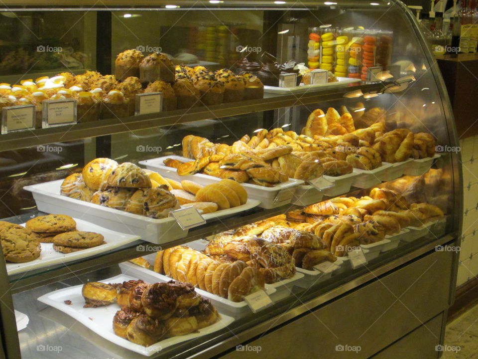 Variety of Freshly Baked Breads, Cookies and Pastries on Display in a Glass Case