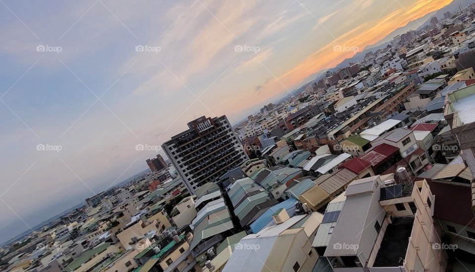 Ordinary buildings shot at an oblique angle, with clouds in the background. 
Dutch Angle Shot.