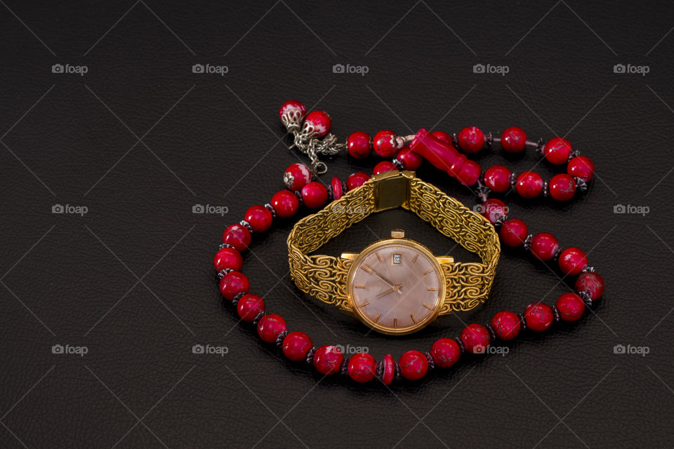 string of beads for keeping count of prayers with a gold watch in the middle