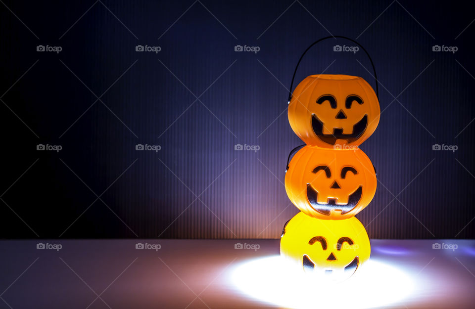 Three orange Halloween Jack o Lantern with lighting