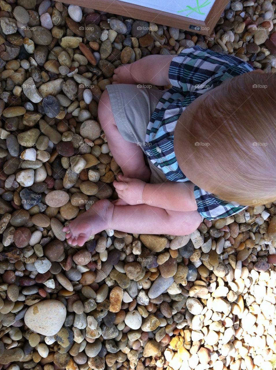 Baby playing with rocks