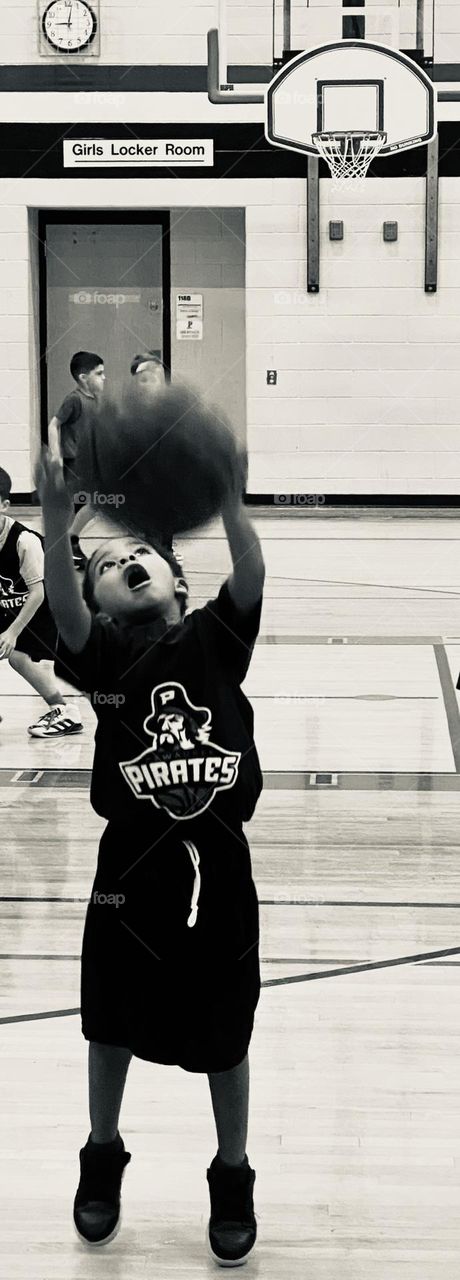 Just a boy playing basketball