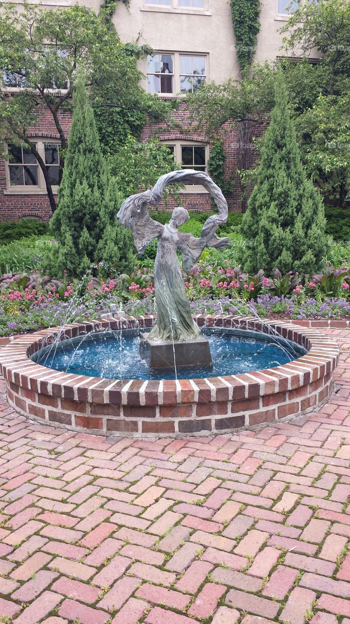 woman in fountain. fountain in garden