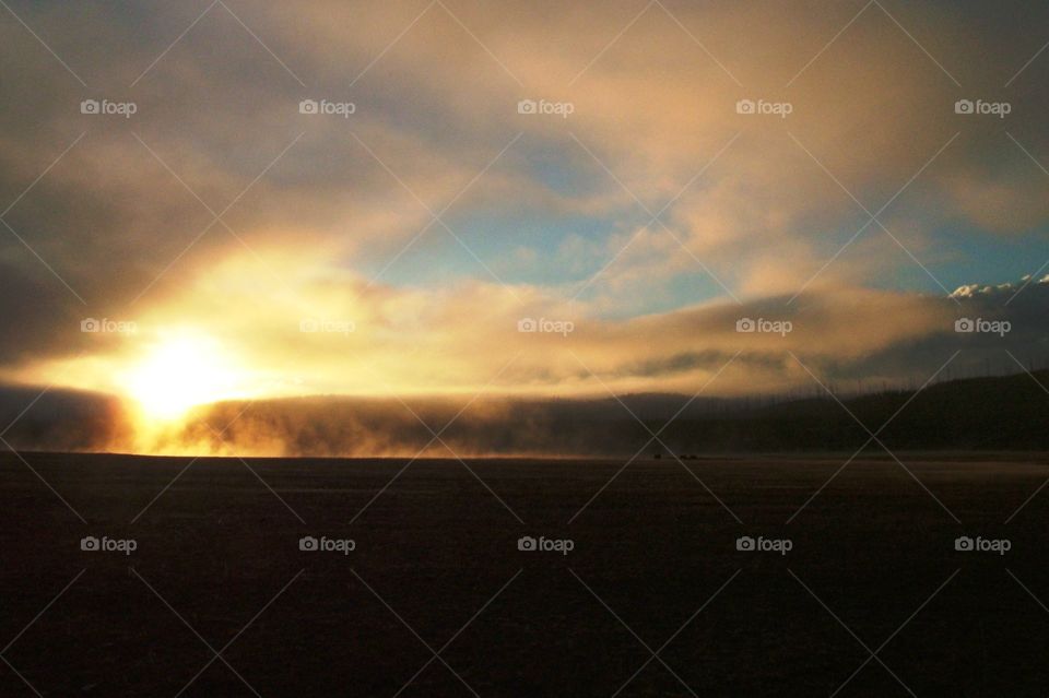 sunrise over a hot spring in Yellowstone National Park