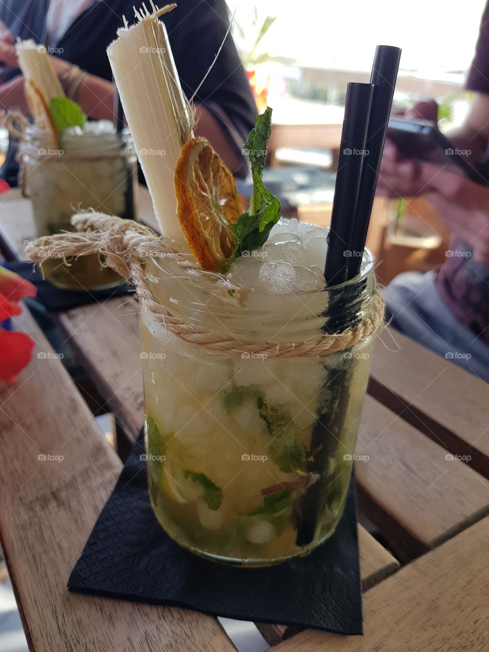 great mojito cocktail with a lot of ice and nice decoration, like sugar cane and straws
