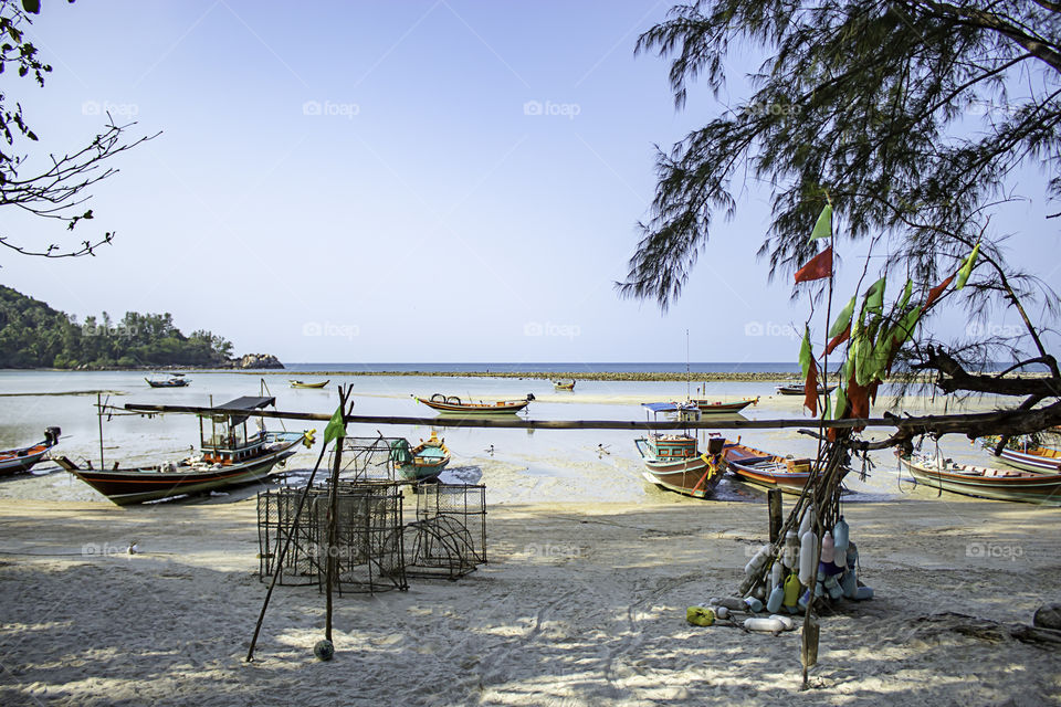 Fishing boats parked on the Beach at Koh Phangan, Surat Thani in Thailand.