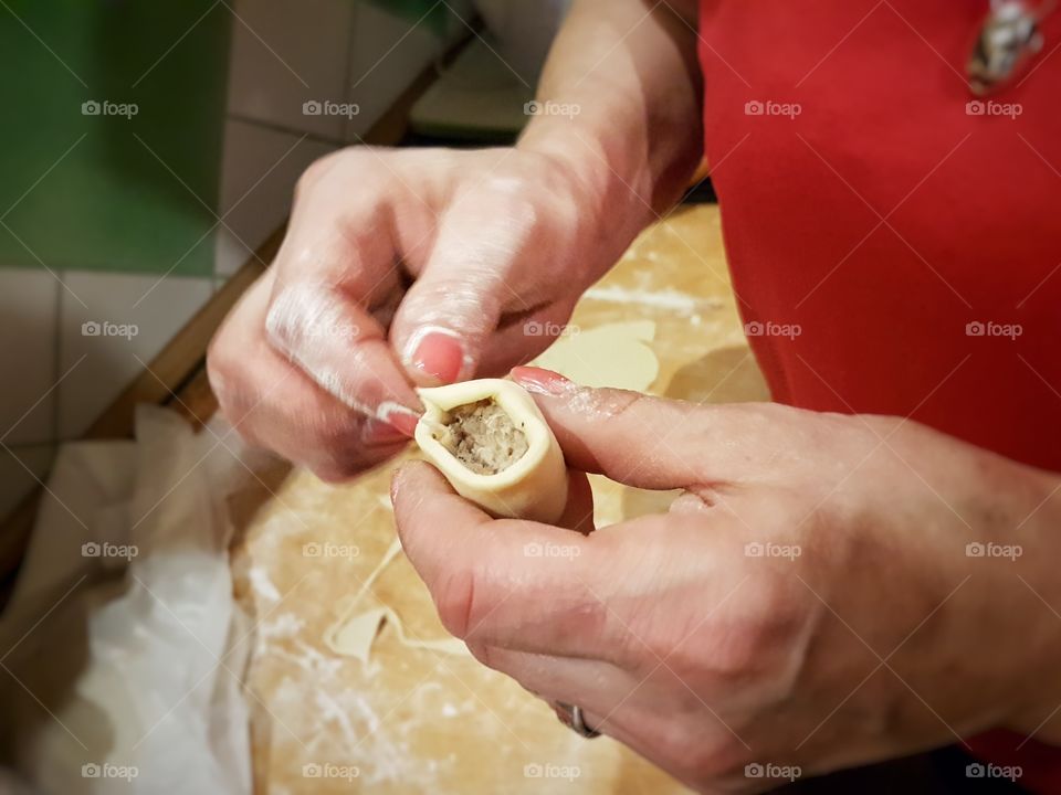 A person making polish pierogi