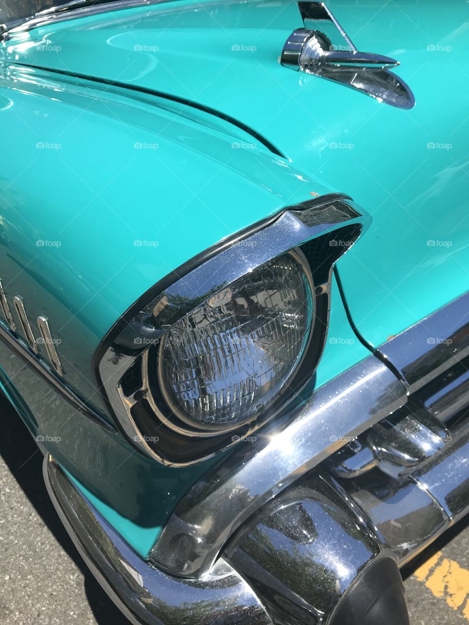 Turquoise Vintage car headlight close up 