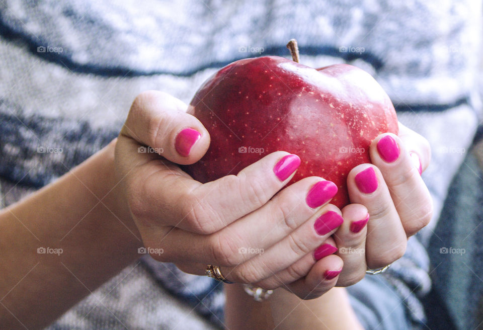 The women holding an apple