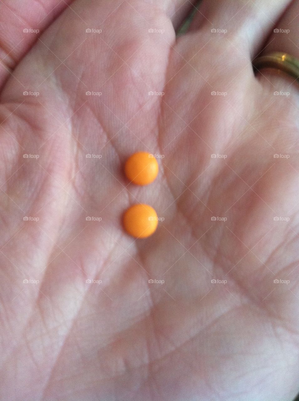 Medication. Hand holding two pills