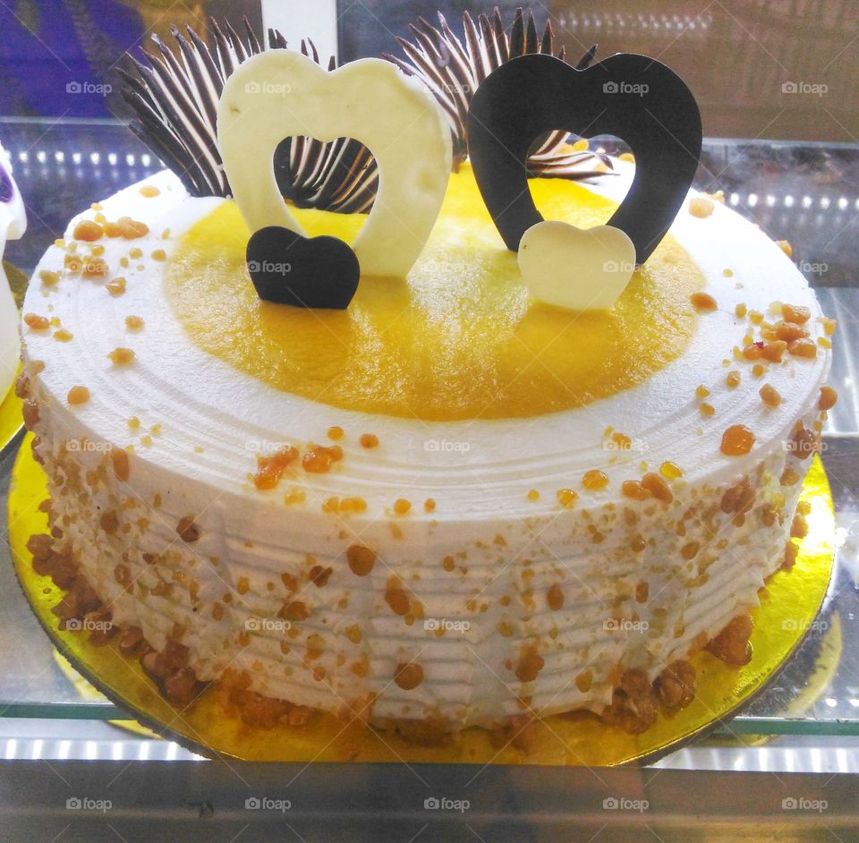 mango flavor white forest round cake baked... it's so sweet