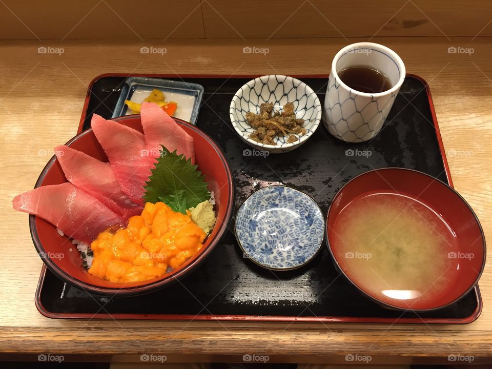 Traditional Japanese sashimi . A typical Japanese sashimi bowl, shown as traditionally served on Tsukiji fish market in Tokyo.