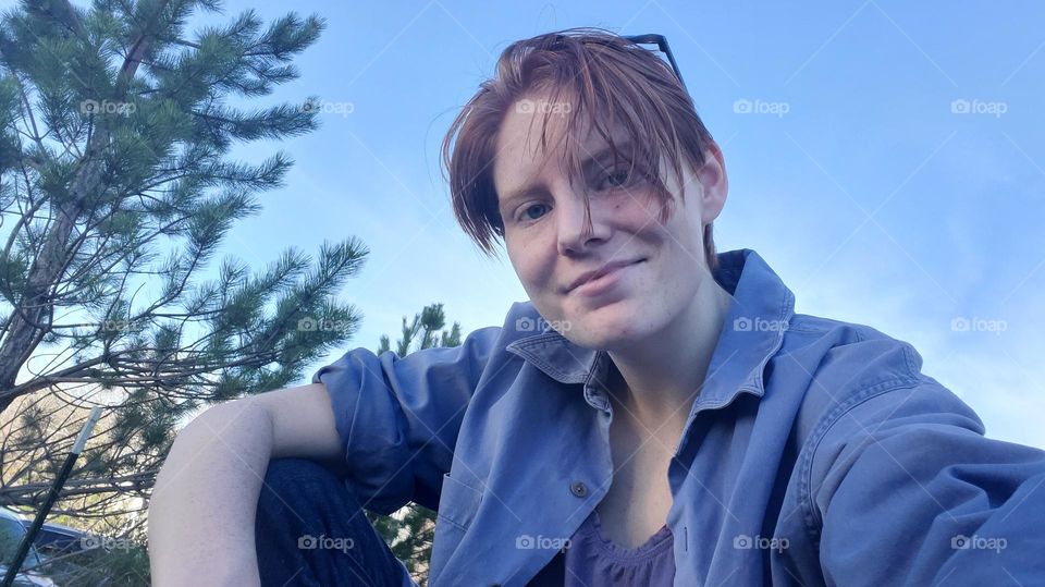 Self Portrait. Short hair with blue sky, sitting