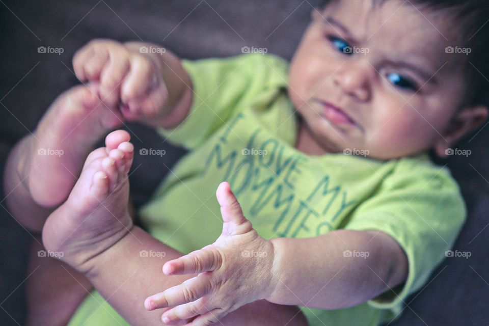 Frustrated and angry baby, angry baby reaching for feet, angry baby girl, I love my mommies, baby girl with an angry look on her face, expressing the emotion of anger